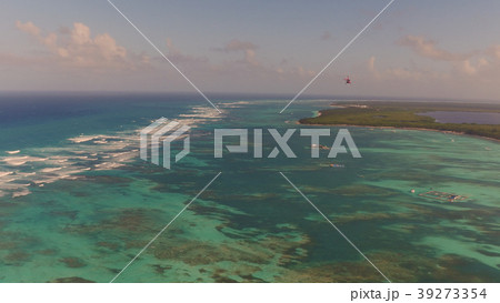 Sea shore with a flying helicopter from above Sea shore with a flying helicopter from above 39273354