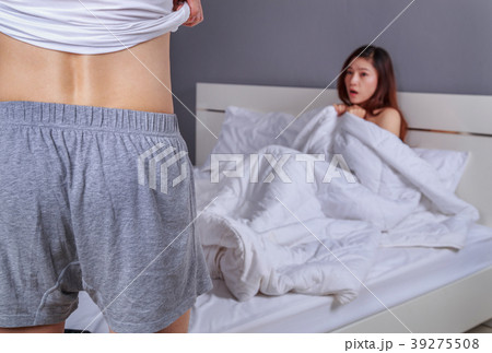 couple in bedroom is having sex, man taking his clothes off with couple in bedroom is having sex, man taking his clothes off with 39275508