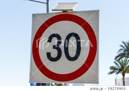 Speed limit sign to 30 with solar panel on road 39279903