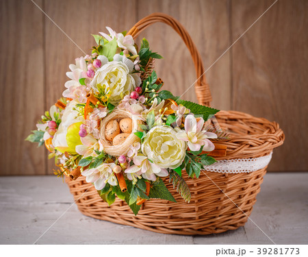 Designer basket is decorated with flowers. Wicker 39281773