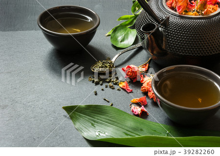 Green tea with rose flower on slate background. 39282260