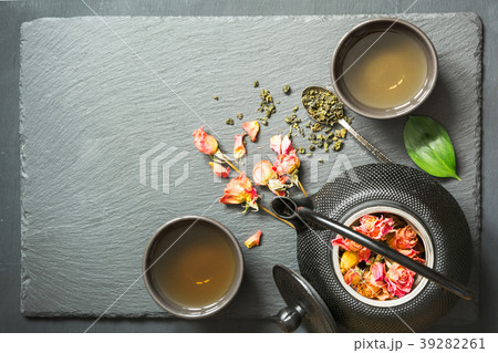 Green tea with rose flower on black background. Green tea with rose flower on black background. 39282261