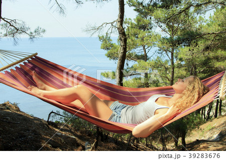 Beautiful young girl resting in a hammock 39283676