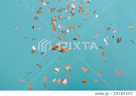 Golden confetti on pink background 39284305