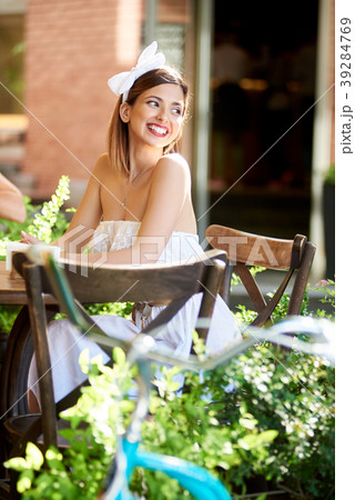 Smiling female sitting in a cosy cafe on a sunny day Smiling female sitting in a cosy cafe on a sunny day 39284769