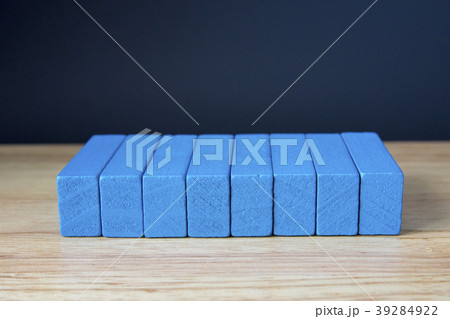 Wooden cubes on table over cement wall background 39284922