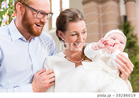 Parents with baby at christening in church 39286019