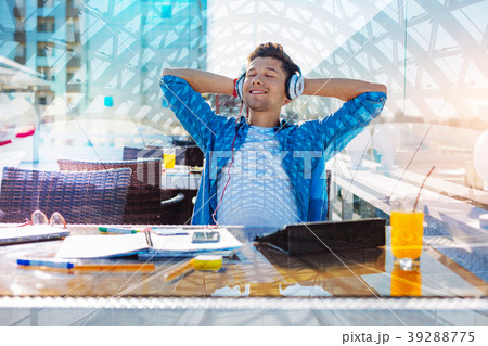 Cheerful man relaxing with his eyes closed Cheerful man relaxing with his eyes closed 39288775