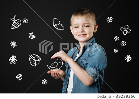 Kind child holding a bird after saving it in the Kind child holding a bird after saving it in the 39289266