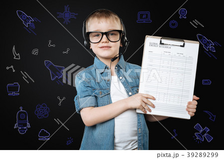 Clever child holding a clipboard while wearing a Clever child holding a clipboard while wearing a 39289299