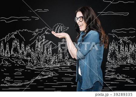 Young woman laughing while holding a little Young woman laughing while holding a little 39289335
