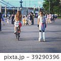 Fashionable girls on rollers and on a bicycle  39290396