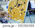Little girl is playing on the board in checkers Go 39290399