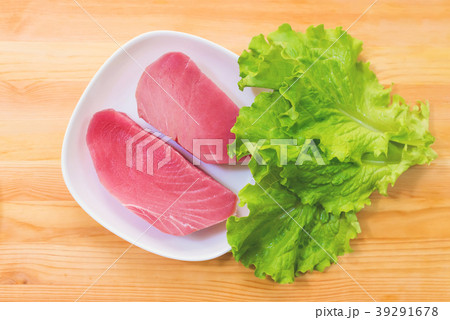 Two pieces of raw fresh tuna fillet on a plate 39291678