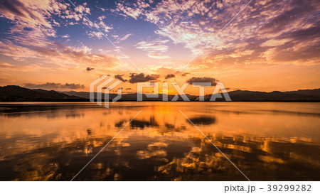 Twilight sky and clouds reflect on water surfa 39299282