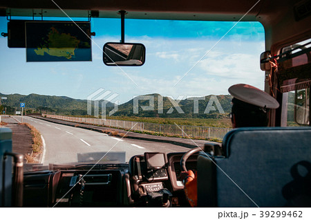 Bus driver driving hands on steering wheel on road 39299462