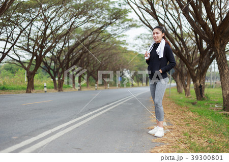 young sporty woman with white towel resting after workout sport 39300801