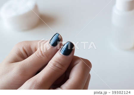 Old dark blue manicure. Shabby nail polish. Old dark blue manicure. Shabby nail polish. 39302124
