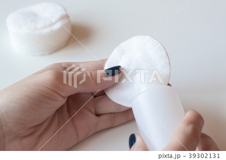 Woman removes the nail polish. Dark blue manicure. Woman removes the nail polish. Dark blue manicure. 39302131