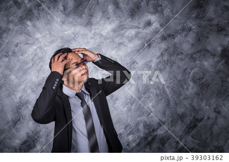 business man in suit with headache and problems 39303162