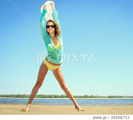 Tanned woman posing at the beach on summer day 39306752