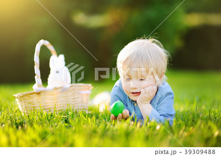 Charming little boy hunting for easter egg Charming little boy hunting for easter egg 39309488