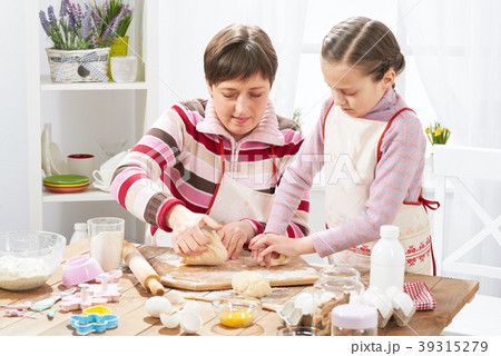 Mother and daughter cooking at home, making dough Mother and daughter cooking at home, making dough 39315279