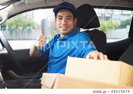 Delivery driver driving car with packages Delivery driver driving car with packages 39315674