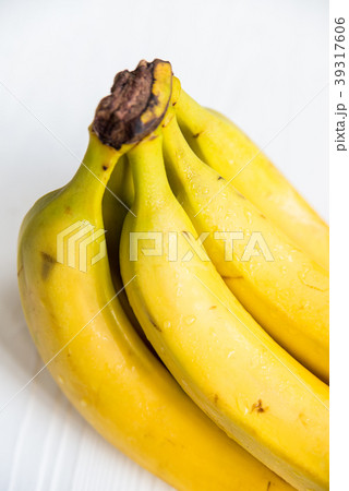 Bunch of bananas on white wooden surface close 39317606