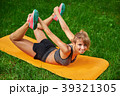 girl doing exercises on the mat in the park on the 39321305