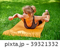 girl doing exercises on the mat in the park on the 39321332