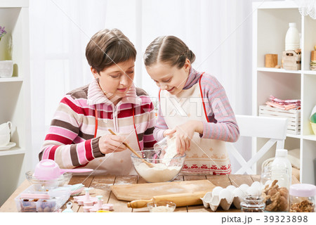 Mother and daughter cook at home. make dough Mother and daughter cook at home. make dough 39323898
