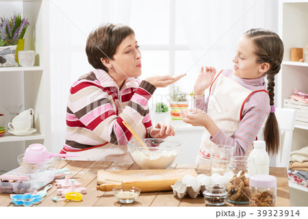 Mother and daughter cook at home. make dough Mother and daughter cook at home. make dough 39323914