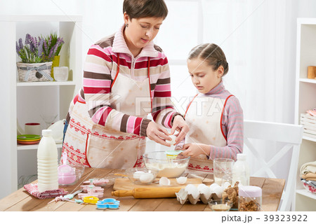 Mother and daughter cook at home. make dough 39323922