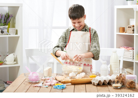 Boy cooking at home, making dough, buns and cookie 39324162