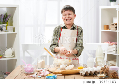 Boy cooking at home, making dough, buns and cookie 39324163