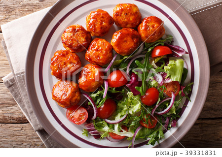 Tasty glazed meatballs with fresh vegetable salad Tasty glazed meatballs with fresh vegetable salad 39331831