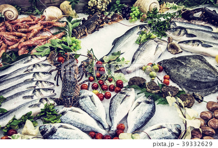 Fresh raw seafoods on counter in restaurant, blue  39332629