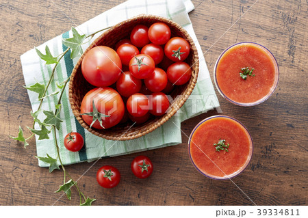 Tomato and tomato juice on a wooden table Tomato and tomato juice on a wooden table 39334811