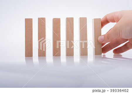 Hand holding wooden domino 39336402
