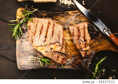 Grilled steak on wooden cutting board 39337221