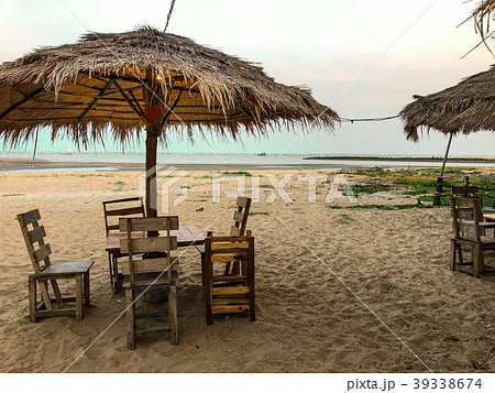 Side of chairs set with umbrella on the beach back 39338674