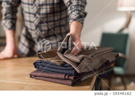 closeup. Selects wool from the stack. Young man closeup. Selects wool from the stack. Young man 39346162