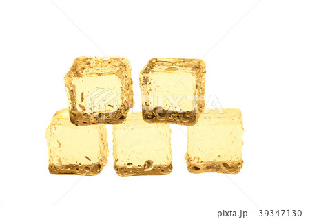Golden ice cubes on white background. 39347130