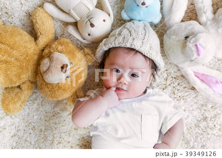 Baby boy with his stuffed animals on a carpet Baby boy with his stuffed animals on a carpet 39349126