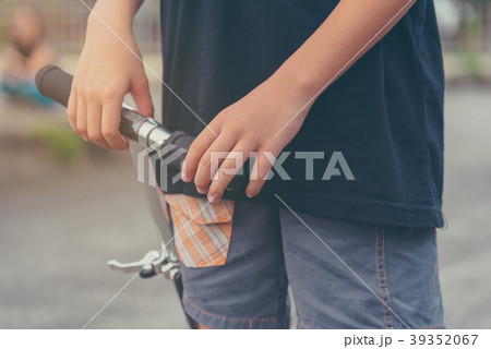 Asian boy playing scooter on street. Asian boy playing scooter on street. 39352067