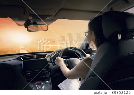 woman driving car on urban highway 39352129