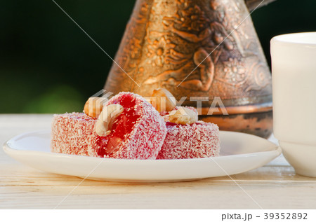 Red Turkish delight with nuts in the sun, pots Red Turkish delight with nuts in the sun, pots 39352892