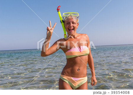 Cheerful woman wearing snorkeling mask Cheerful woman wearing snorkeling mask 39354008