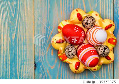 Several colorful Easter eggs in decorative tray 39363375